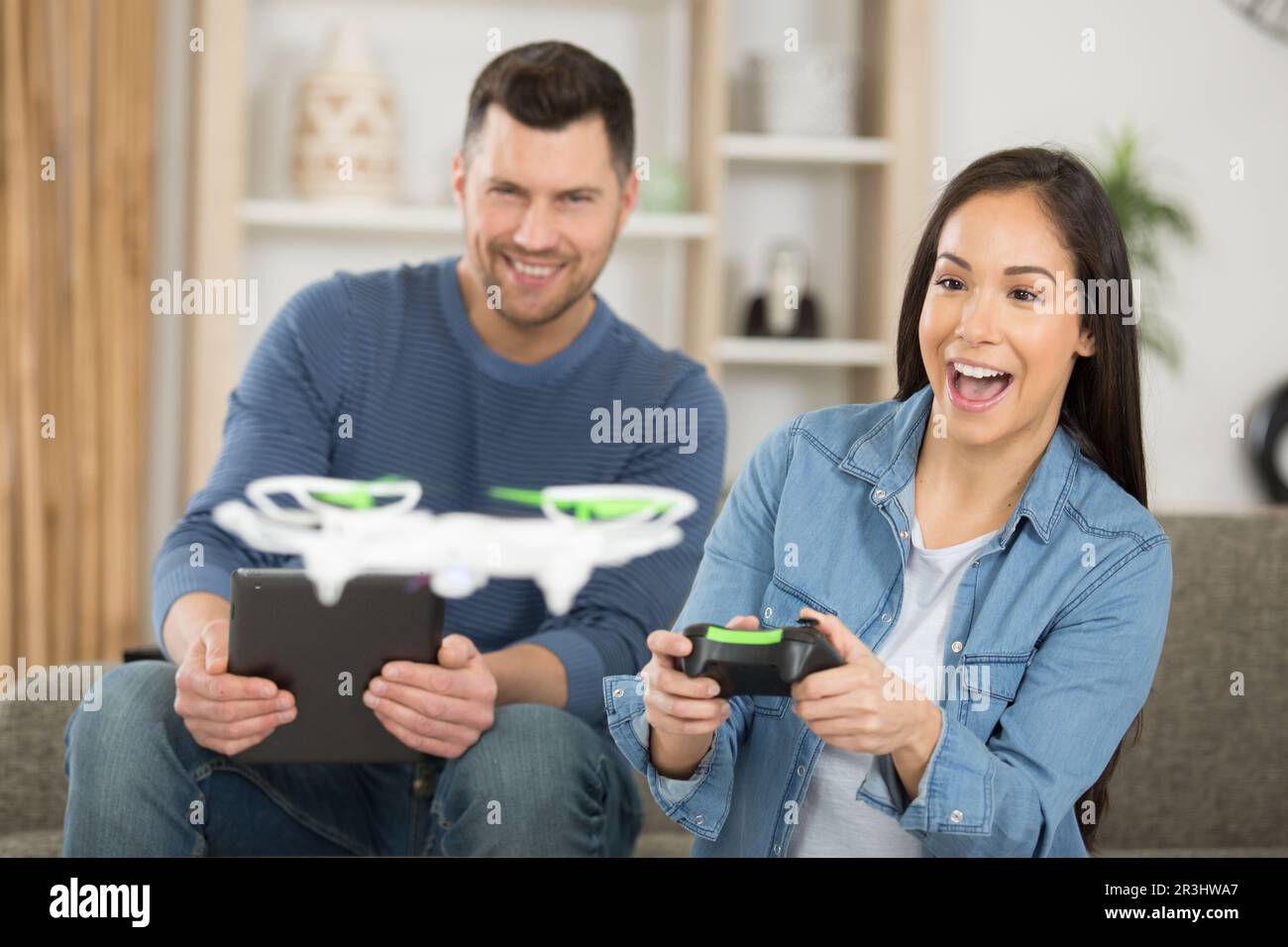 happy couple using modern drone Stock Photo