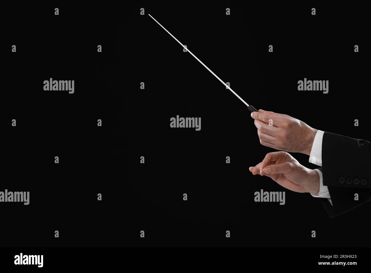 Professional conductor with baton on black background, closeup. Space