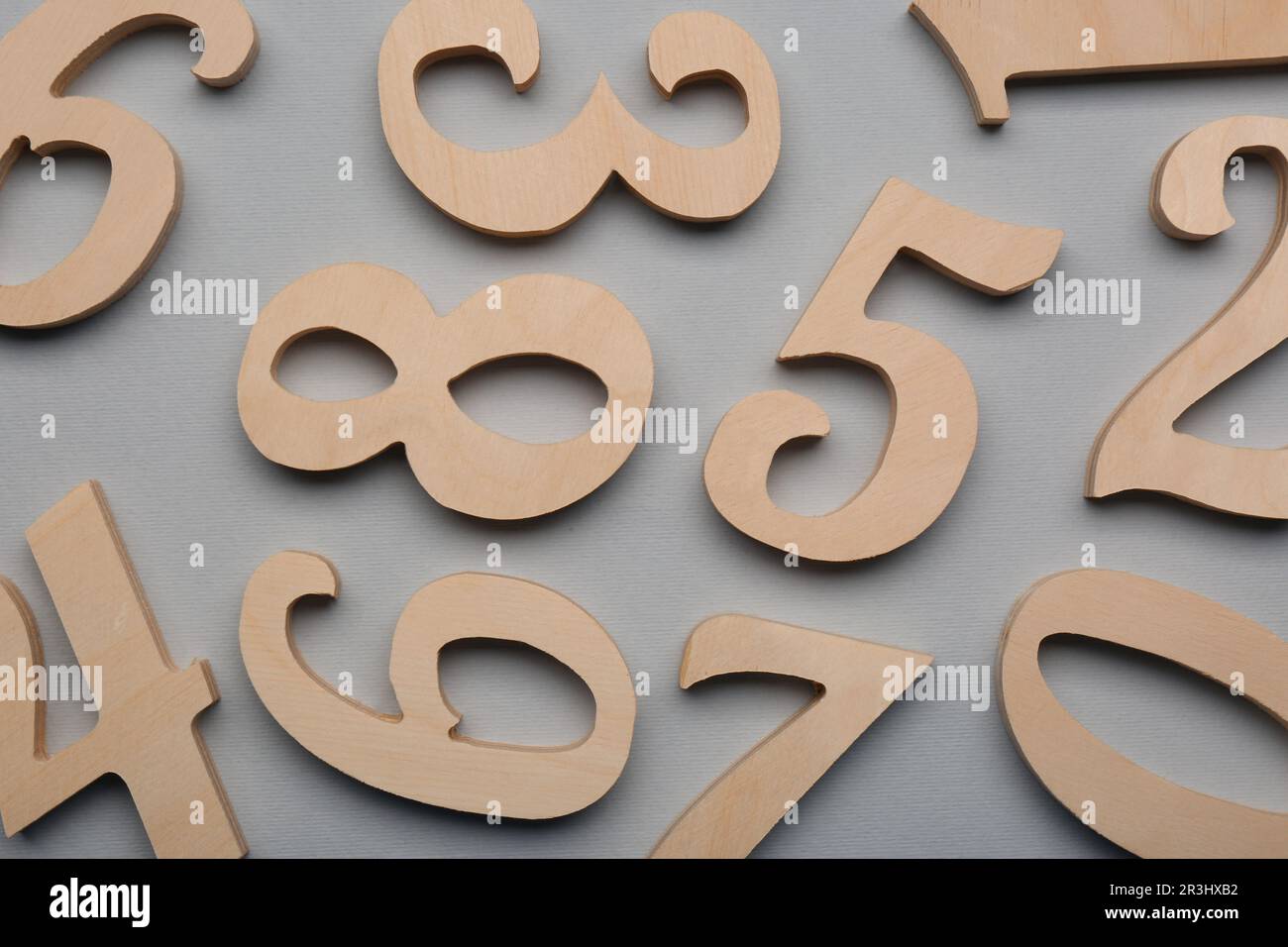 Wooden numbers on light grey background, flat lay Stock Photo - Alamy