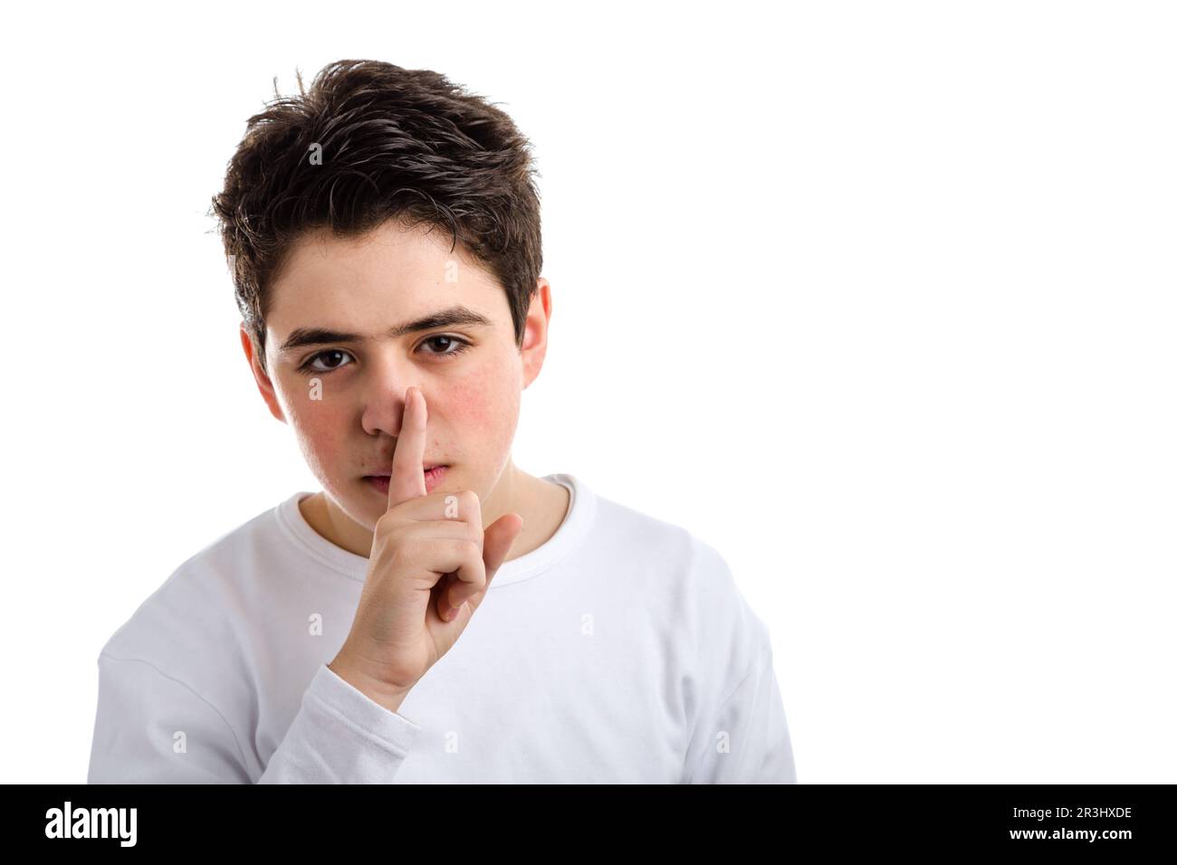 Be silent gesture by Caucasian teenager with acne skin Stock Photo