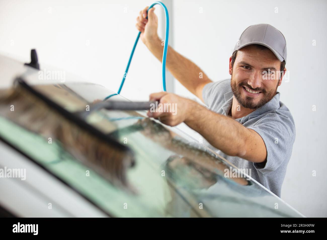 gas station worker cleaning windshield at service station Stock Photo Alamy