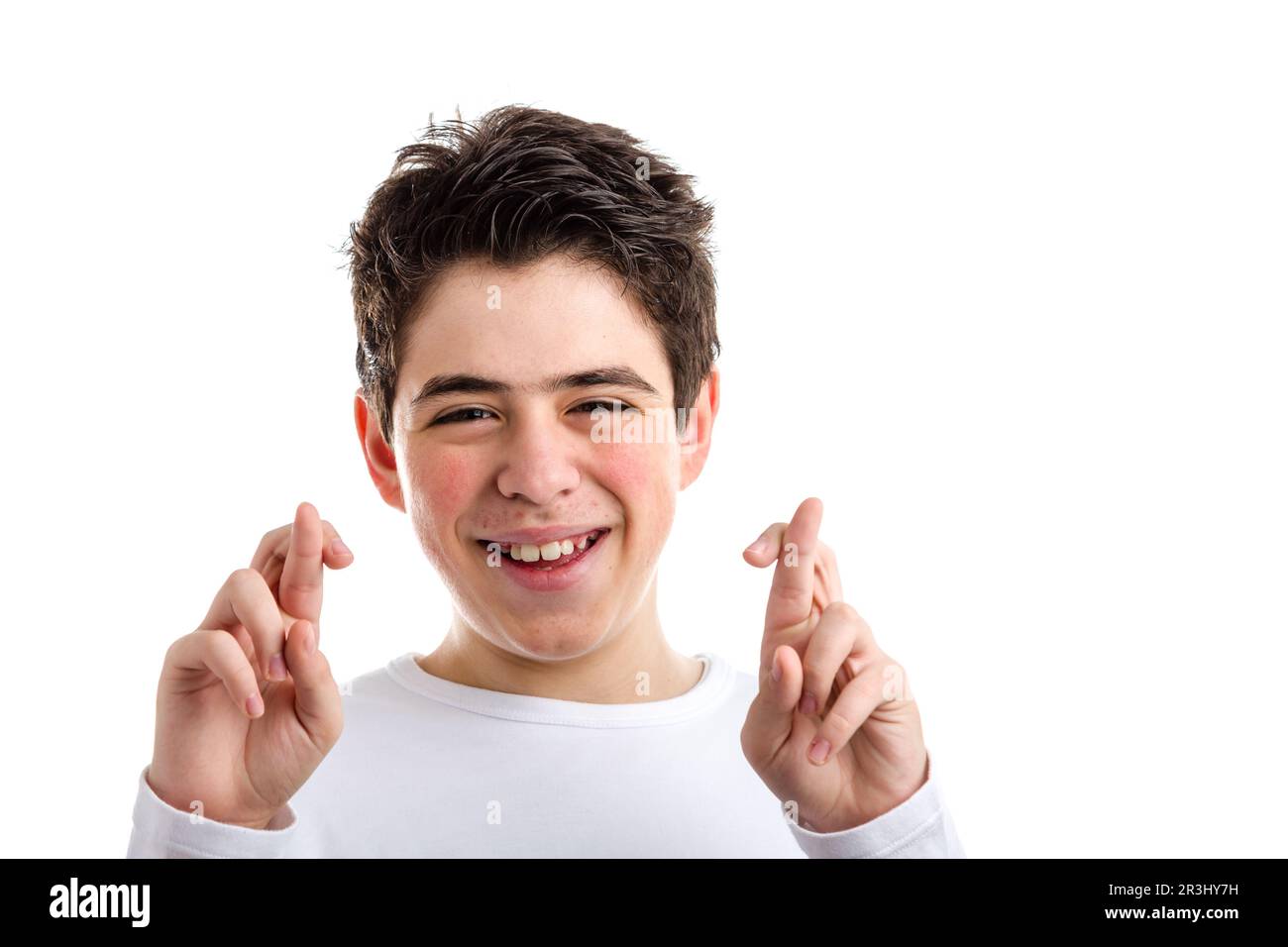 Crossed fingers as lucky gesture by Latin young boy with acne Stock