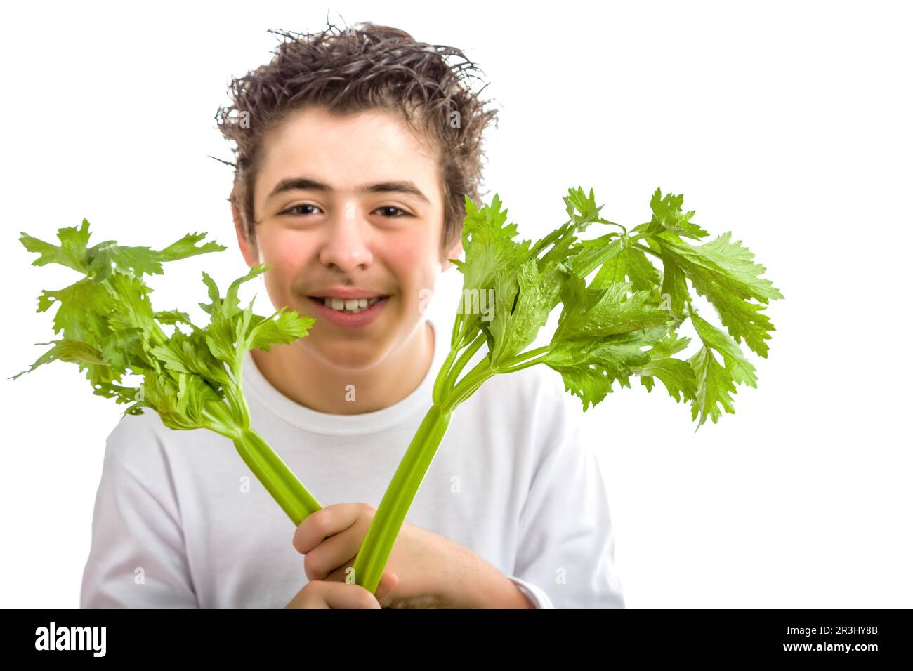 Happy boy with soft skin holding celery sticks Stock Photo Alamy
