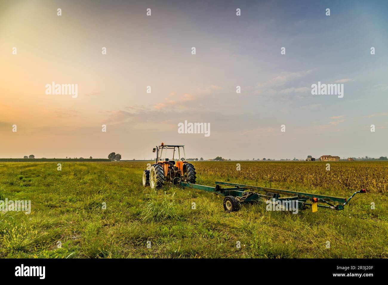Tractor and harvested land Stock Photo - Alamy