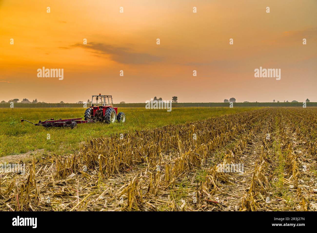 Tractor and harvested land Stock Photo - Alamy