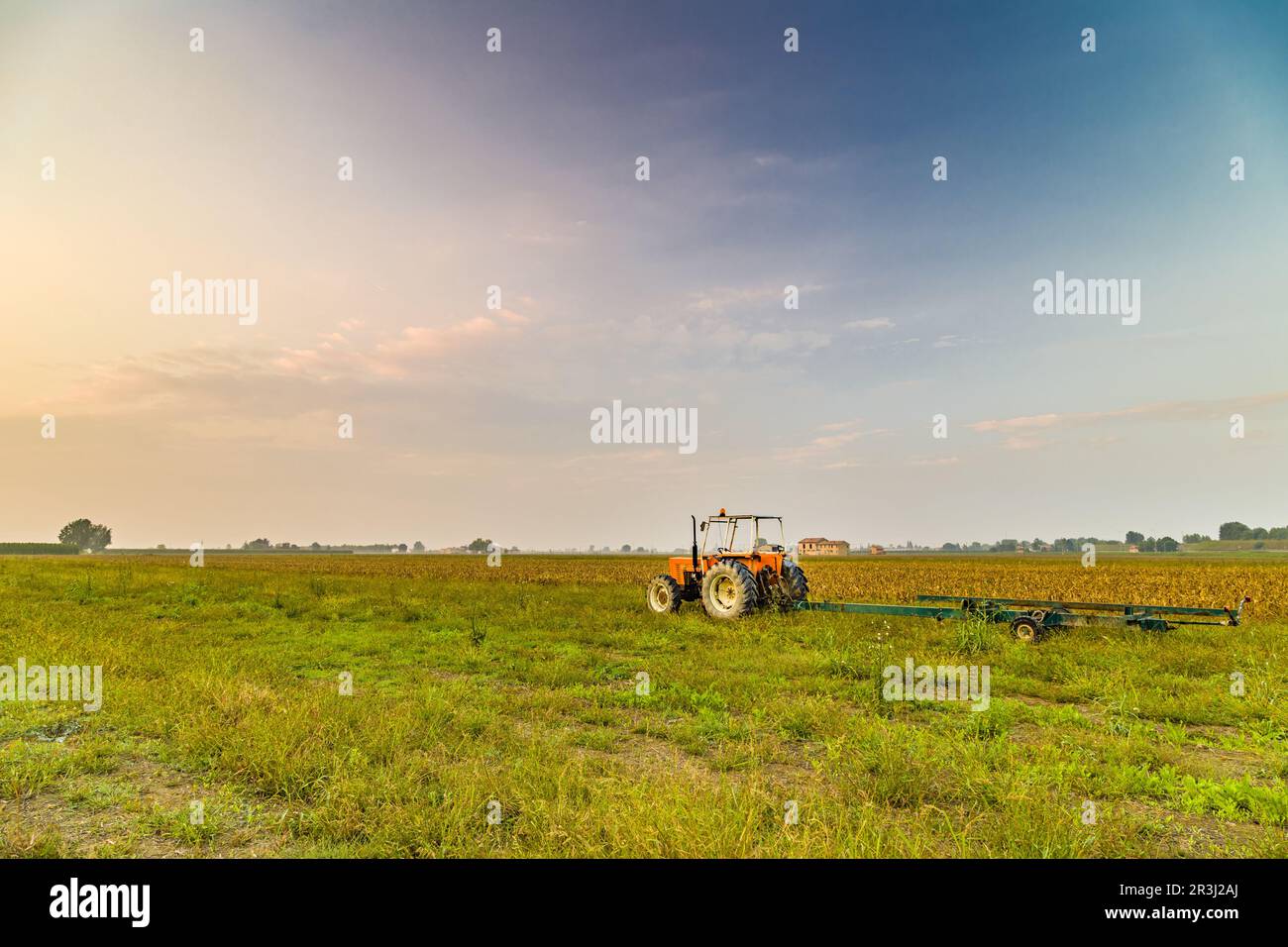 Tractor and harvested land Stock Photo - Alamy