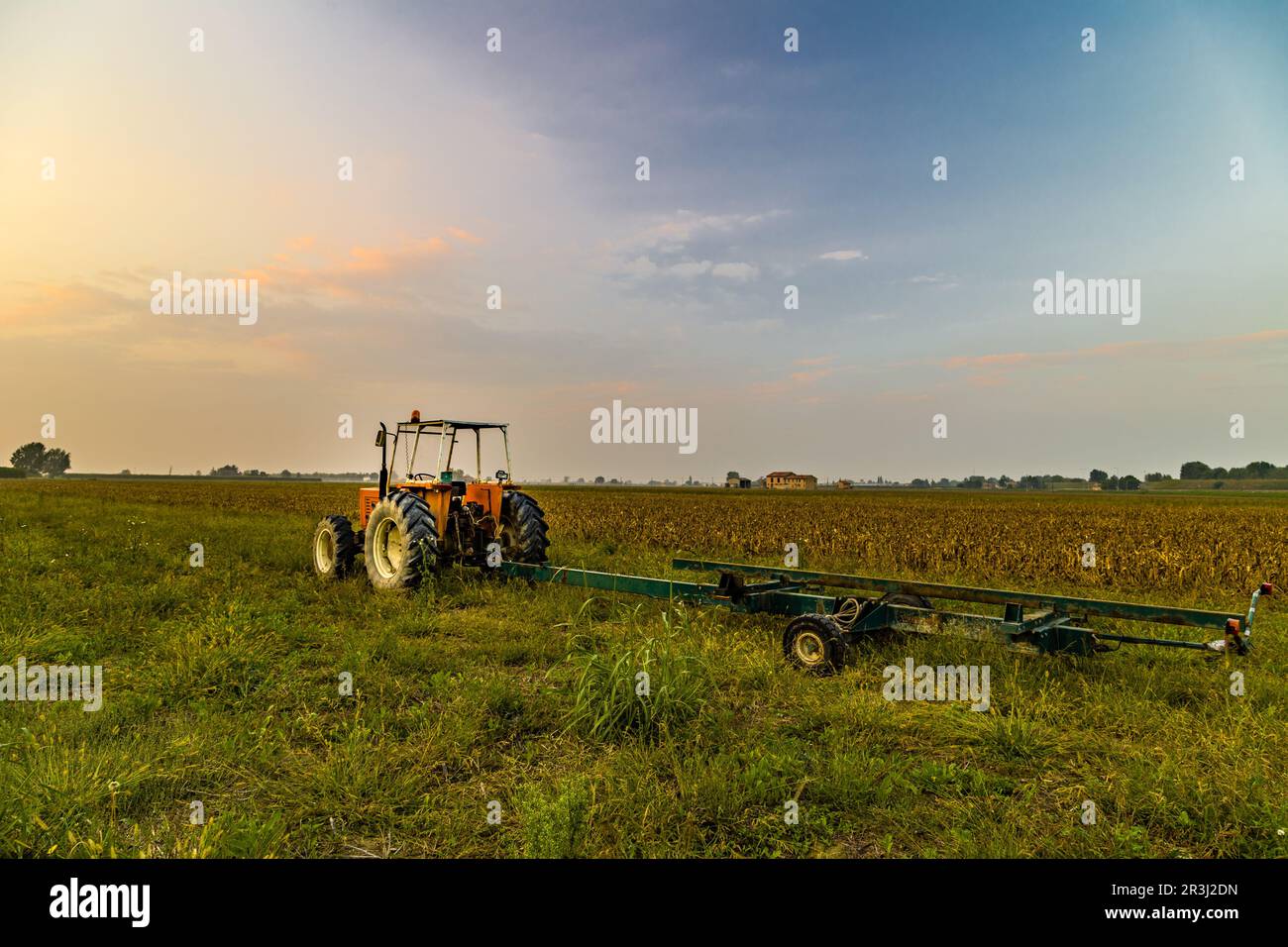 Tractor and harvested land Stock Photo - Alamy