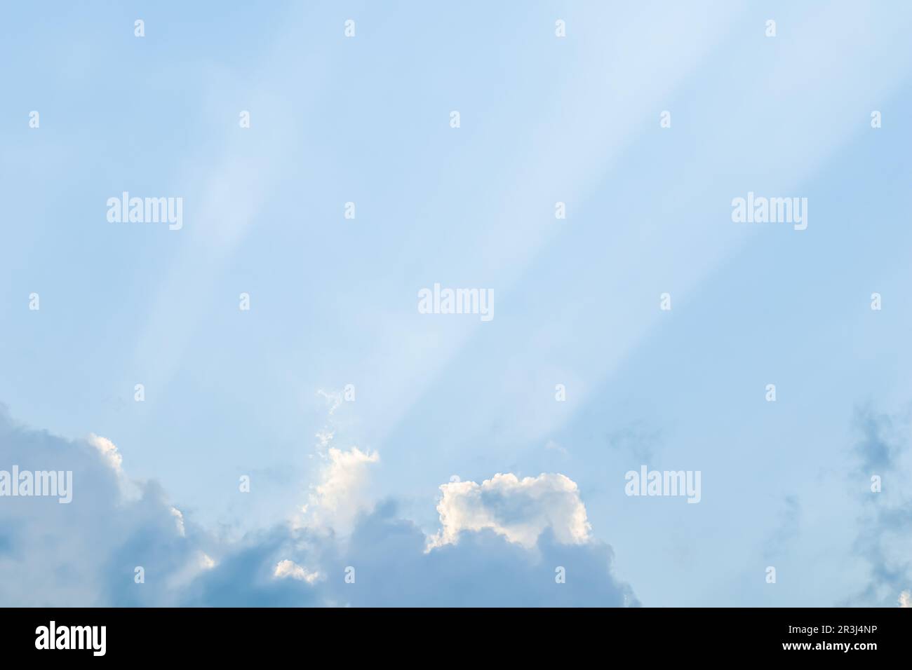 Background from blue sky with sun rays across clouds Stock Photo - Alamy