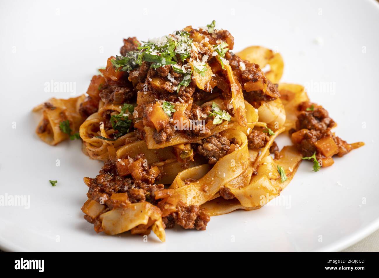 Tagliatelle pasta with bolognaise on a white plate Stock Photo