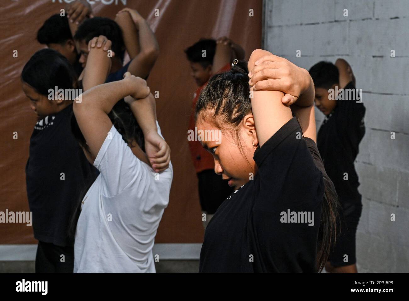 Bogor, Indonesia. 23rd May, 2023. Children warms up before practice weightlifting at Batavia Bersatu Maju (BBM) gym in Parung Panjang district in Bogor, West Java, Indonesia, on May 23, 2023. BBM gym is established in 2021 by Deni, a former Indonesian weightlifter who was placed the first position in Southeast Asian Games 2019. Children from 9 to 17 years old participate in daily weightlifting training here for free. Credit: Agung Kuncahya B./Xinhua/Alamy Live News Stock Photo