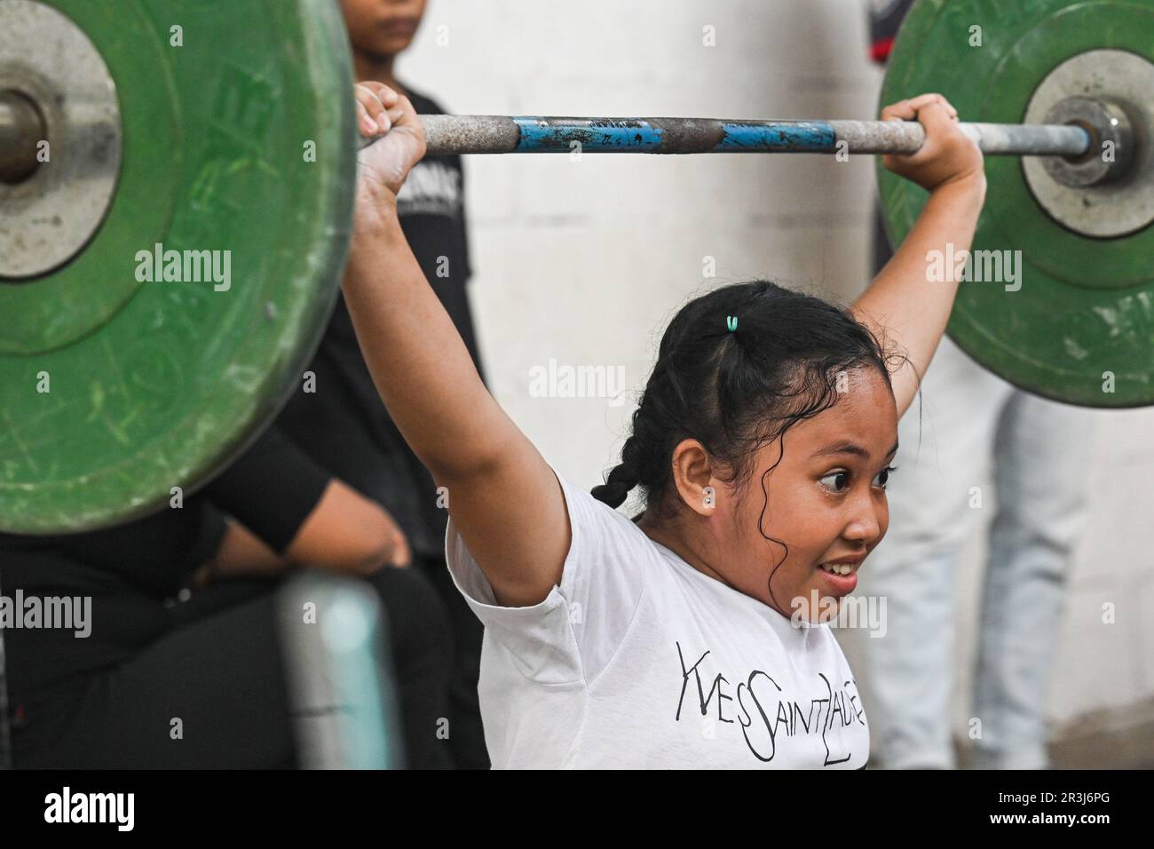 Bogor, Indonesia. 23rd May, 2023. A girl practices weightlifting at Batavia Bersatu Maju (BBM) gym in Parung Panjang district in Bogor, West Java, Indonesia, on May 23, 2023. BBM gym is established in 2021 by Deni, a former Indonesian weightlifter who was placed the first position in Southeast Asian Games 2019. Children from 9 to 17 years old participate in daily weightlifting training here for free. Credit: Agung Kuncahya B./Xinhua/Alamy Live News Stock Photo