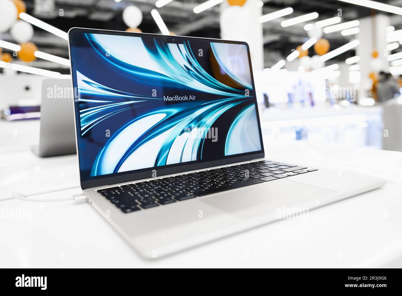Macbook Air is turned on on the table in the store Stock Photo