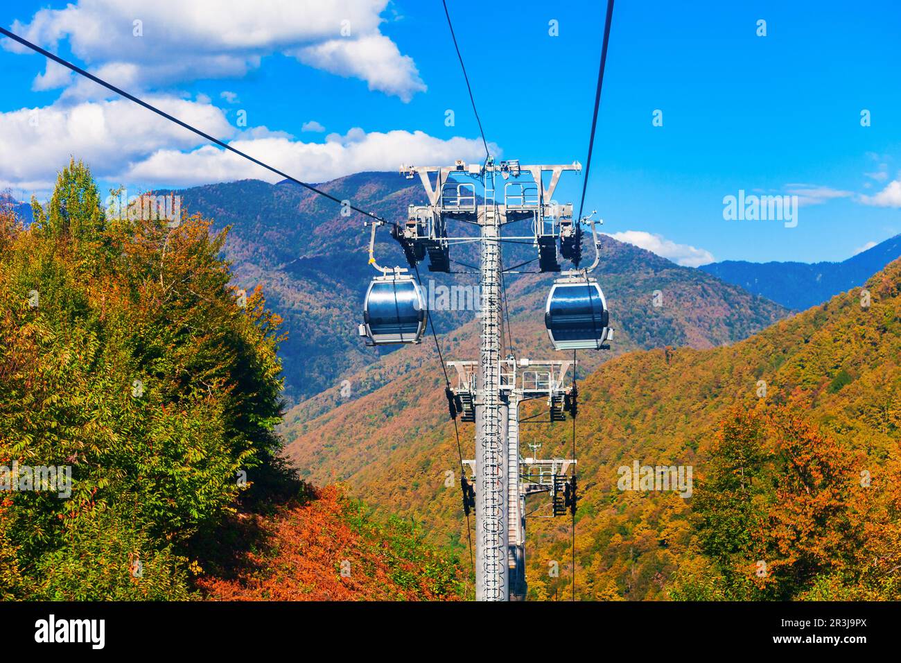 Cable car cabin rises up from Rosa Khutor village to Roza Peak mountain in Sochi resort city in Krasnodar Krai, Russia Stock Photo