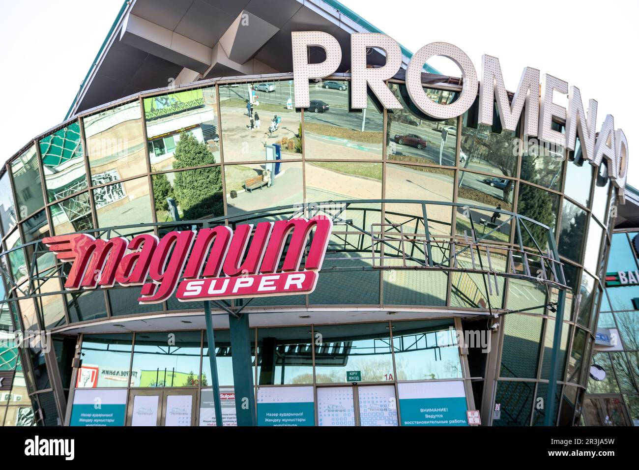 Signboard of a large supermarket chain Magnum on the facade of the Promenade shopping center in Almaty Stock Photo