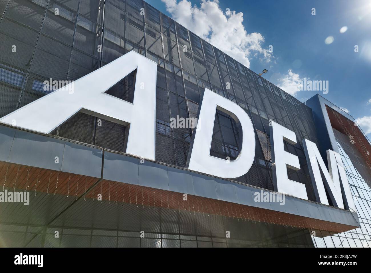The facade of the covered market with the name Adem in the area of the famous flea market of Almaty Stock Photo