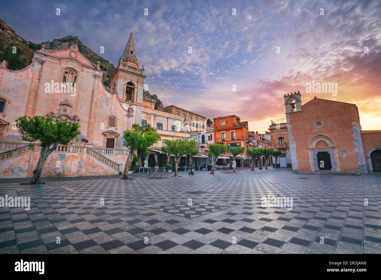 Taormina, Sicily, Italy. Cityscape image of picturesque town of Taormina, Sicily with main square Piazza IX Aprile and San Giuseppe church at sunrise. Stock Photo