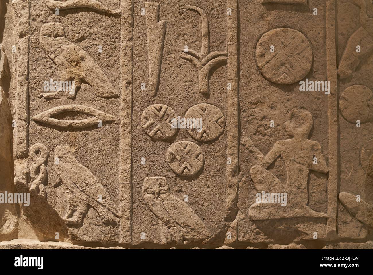 Ancient text in the form of Egyptian hieroglyphics on a wall of limestone Stock Photo