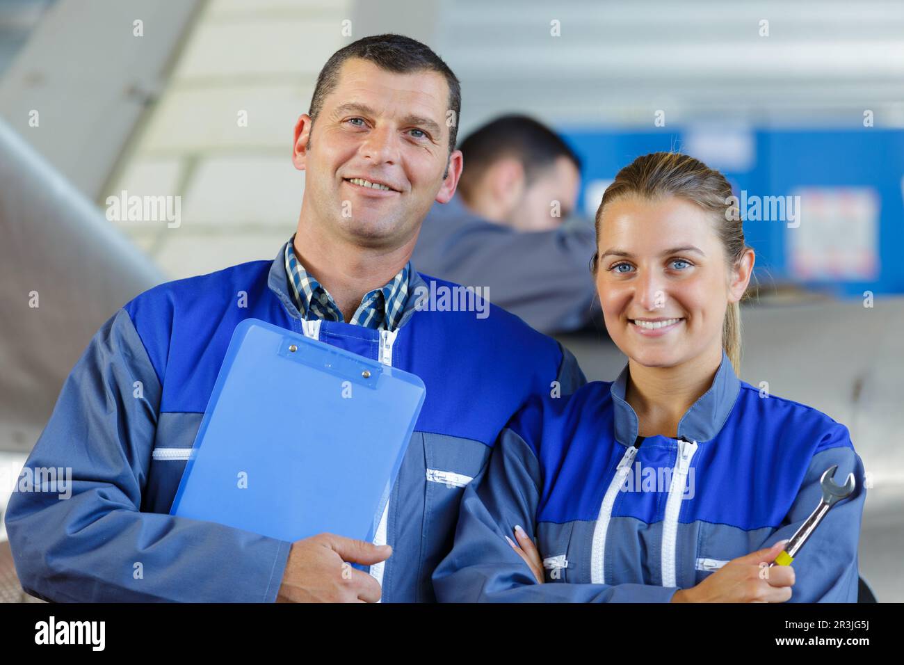 mechanics in hangar repairing light aircraft Stock Photo