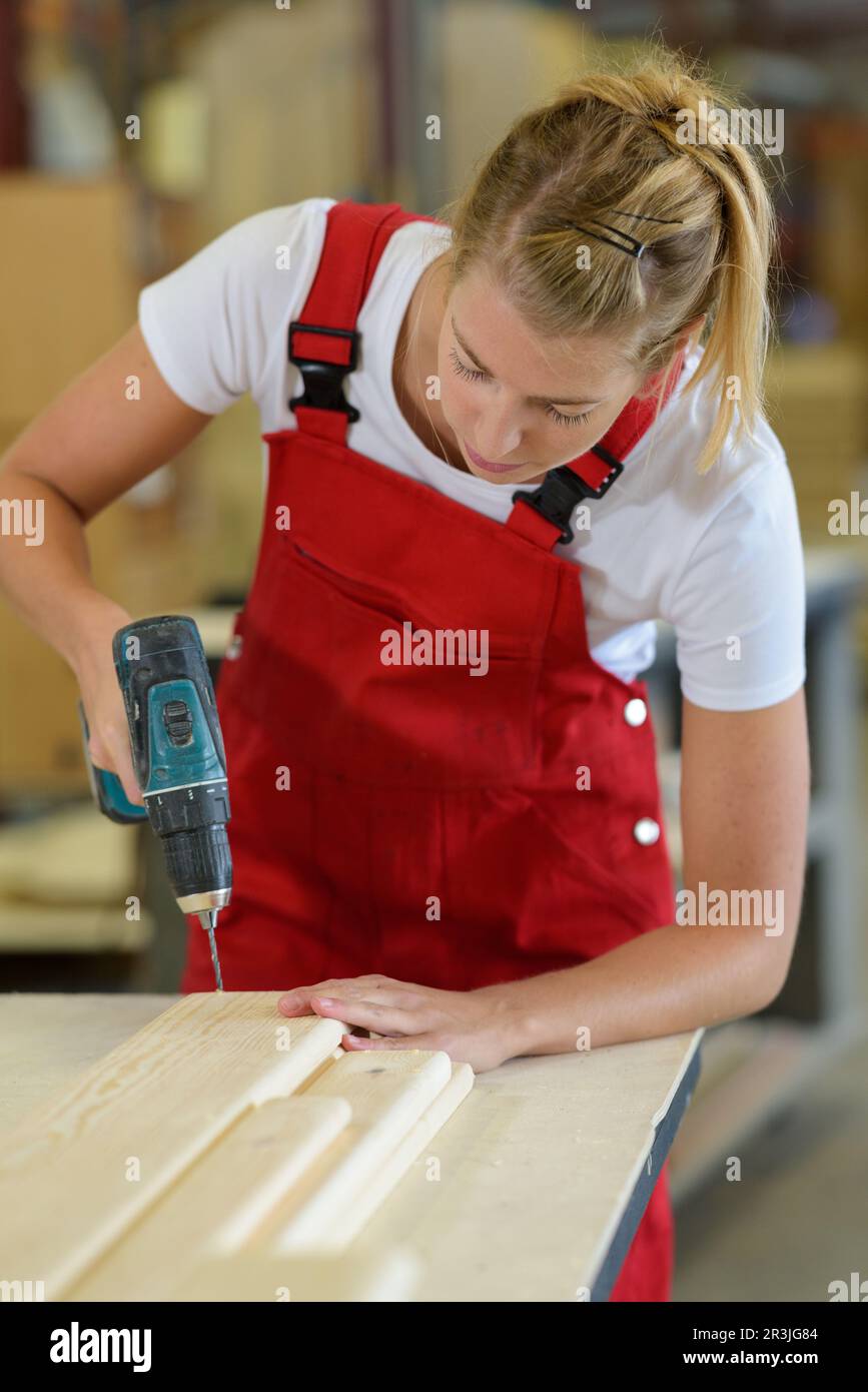 Female carpenter drilling wood hi-res stock photography and images - Alamy