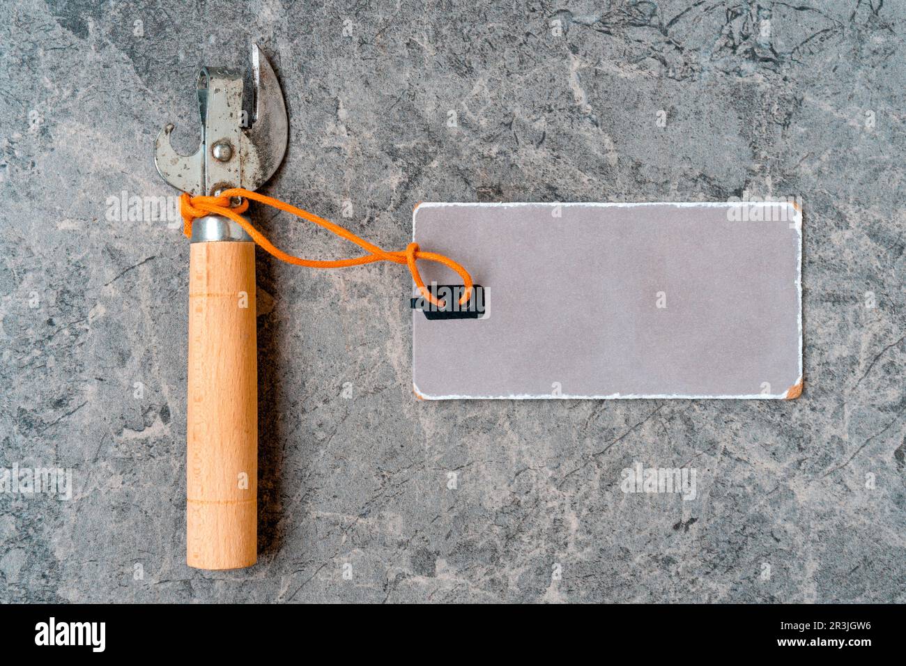 Can opener with with a blank paper tag for copy-space Stock Photo