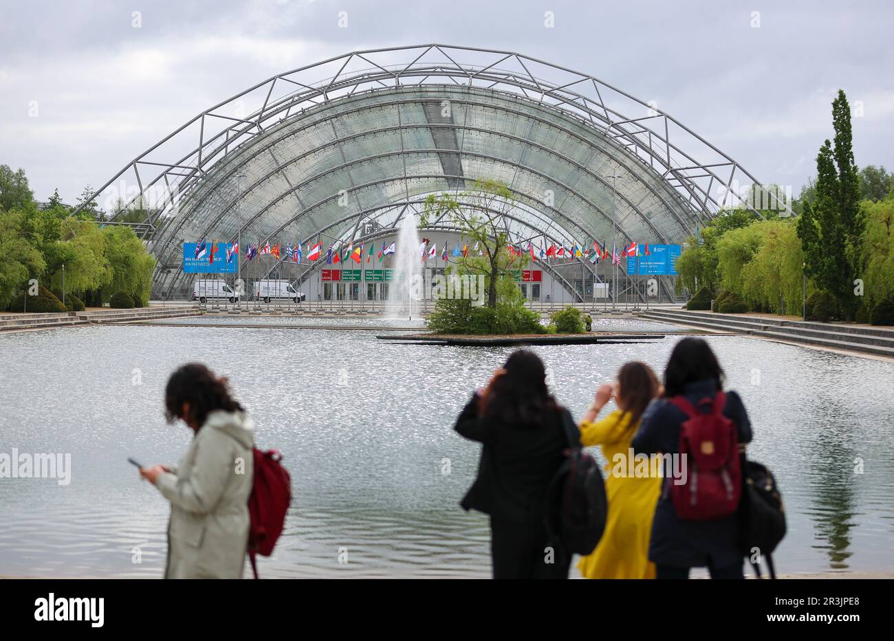 Leipzig, Germany. 24th May, 2023. Participants of the World Summit of Transport Ministers walk to the Congress Center Leipzig (CCL) against the backdrop of the Glass Hall of the Leipzig Trade Fair. Experts from the transport sector from 80 countries will meet here from May 24 to 26. Among other things, the meeting will focus on forecasts for global traffic volumes up to 2050, the International Transport Forum (ITF) announced ahead of the meeting. In addition, global CO2 emissions will be examined and conclusions drawn for transport policy. Credit: Jan Woitas/dpa/Alamy Live News Stock Photo