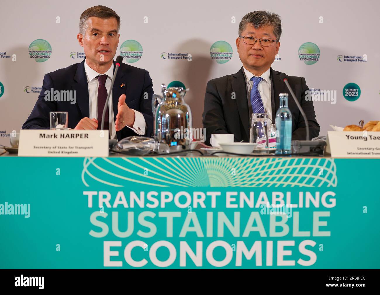 24 May 2023, Saxony, Leipzig: Mark Harper (l), Transport Minister of the United Kingdom, and Young Tae Kim, Secretary General of the International Transport Forum, sit on a podium at the opening of the World Summit of Transport Ministers. Experts from the transport sector from 80 countries will meet here from May 24 to 26. At the beginning of the meeting, the panel will discuss, among other things, forecasts for global traffic volumes up to 2050, the International Transport Forum (ITF) announced ahead of the meeting. In addition, global CO2 emissions will be examined and conclusions drawn for Stock Photo