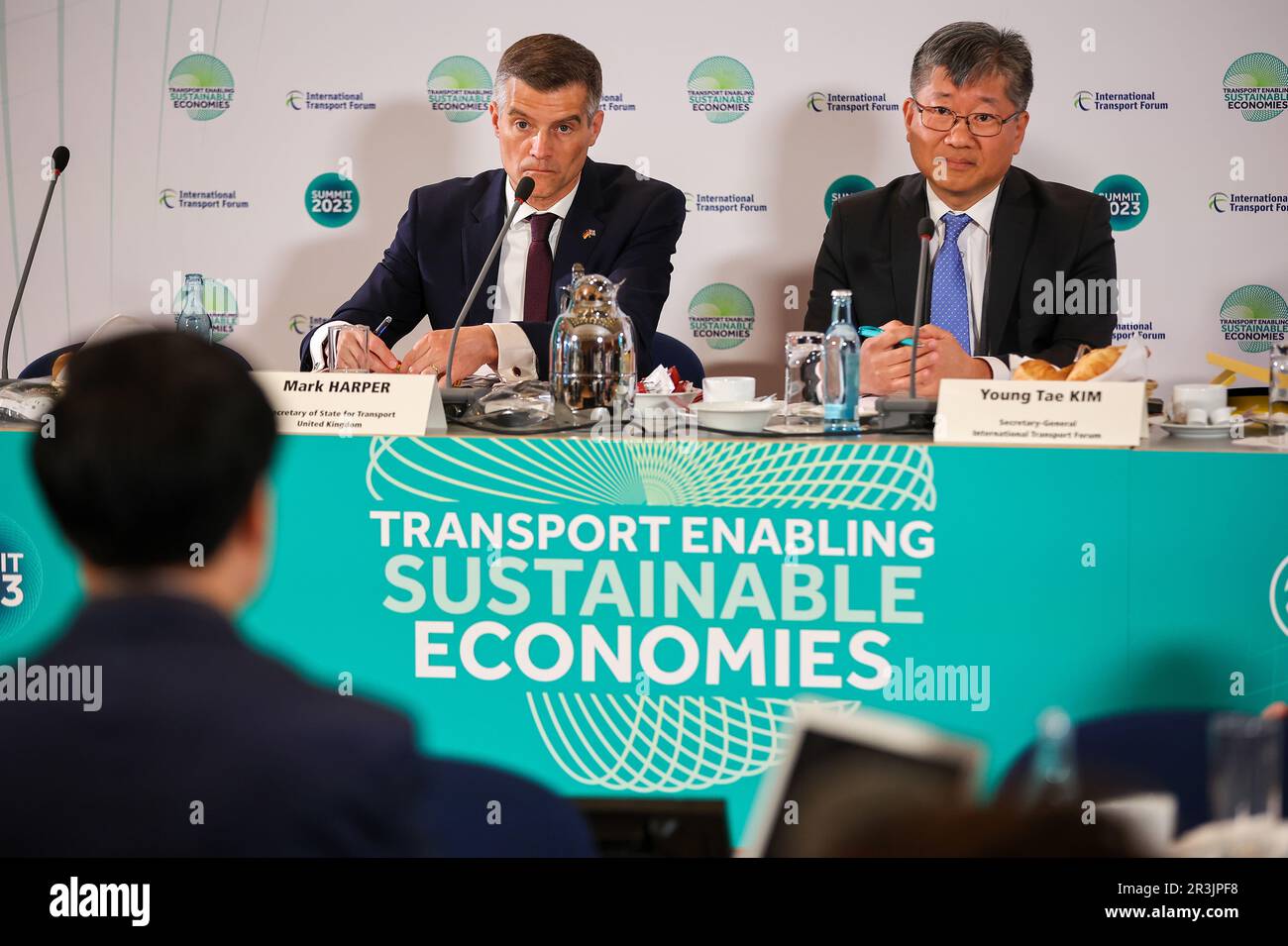 24 May 2023, Saxony, Leipzig: Mark Harper (l), Transport Minister of the United Kingdom, and Young Tae Kim, Secretary General of the International Transport Forum, sit on a podium at the opening of the World Summit of Transport Ministers. Experts from the transport sector from 80 countries will meet here from May 24 to 26. At the beginning of the meeting, the panel will discuss, among other things, forecasts for global traffic volumes up to 2050, the International Transport Forum (ITF) announced ahead of the meeting. In addition, global CO2 emissions will be examined and conclusions drawn for Stock Photo