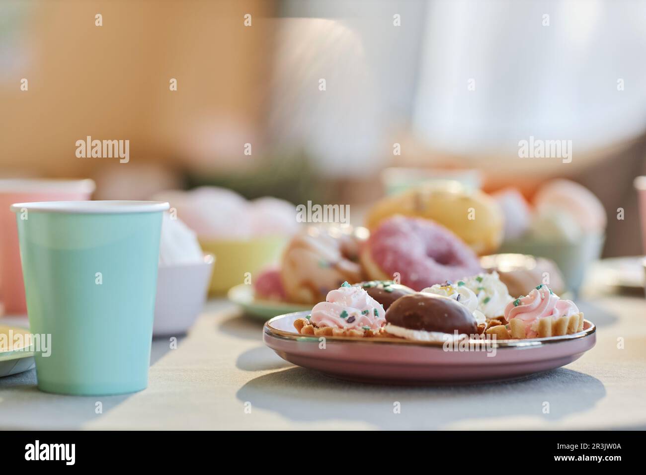 Closeup background image of table with sweets and donuts at kids party, copy space Stock Photo