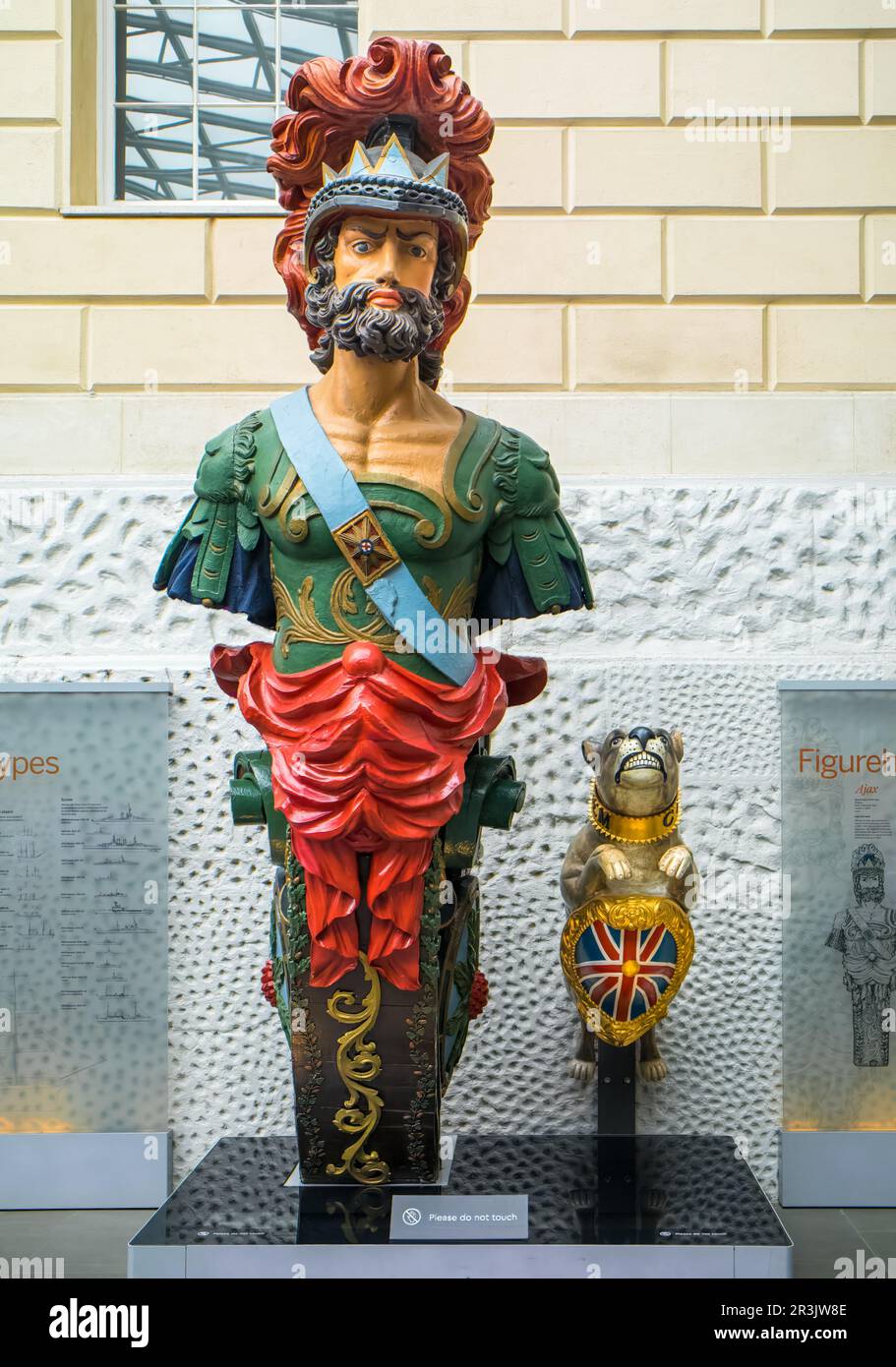 Historic British Navy figureheads on display at the National Maritime Museum (NMM) in London, UK. On left is the figurehead from HMS Ajax, a 74-gun fr Stock Photo