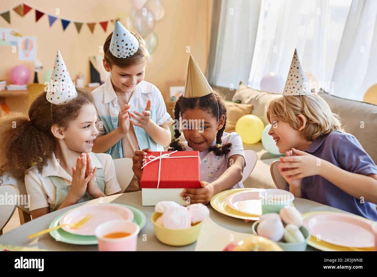 Diverse group of happy children at Birthday party with little black ...