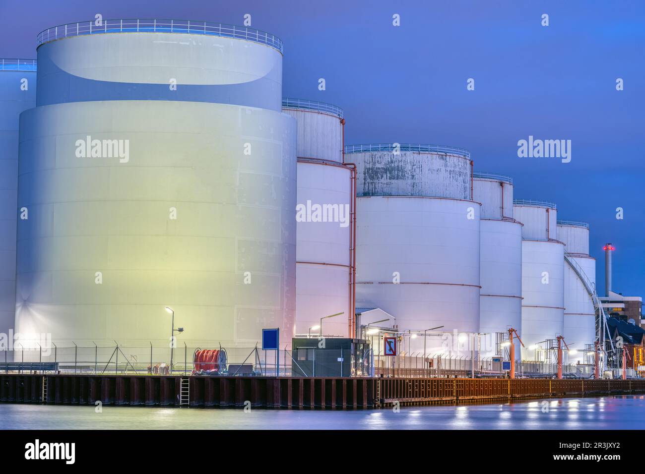 Storage tanks for fossil fuels at night seen in Berlin Stock Photo