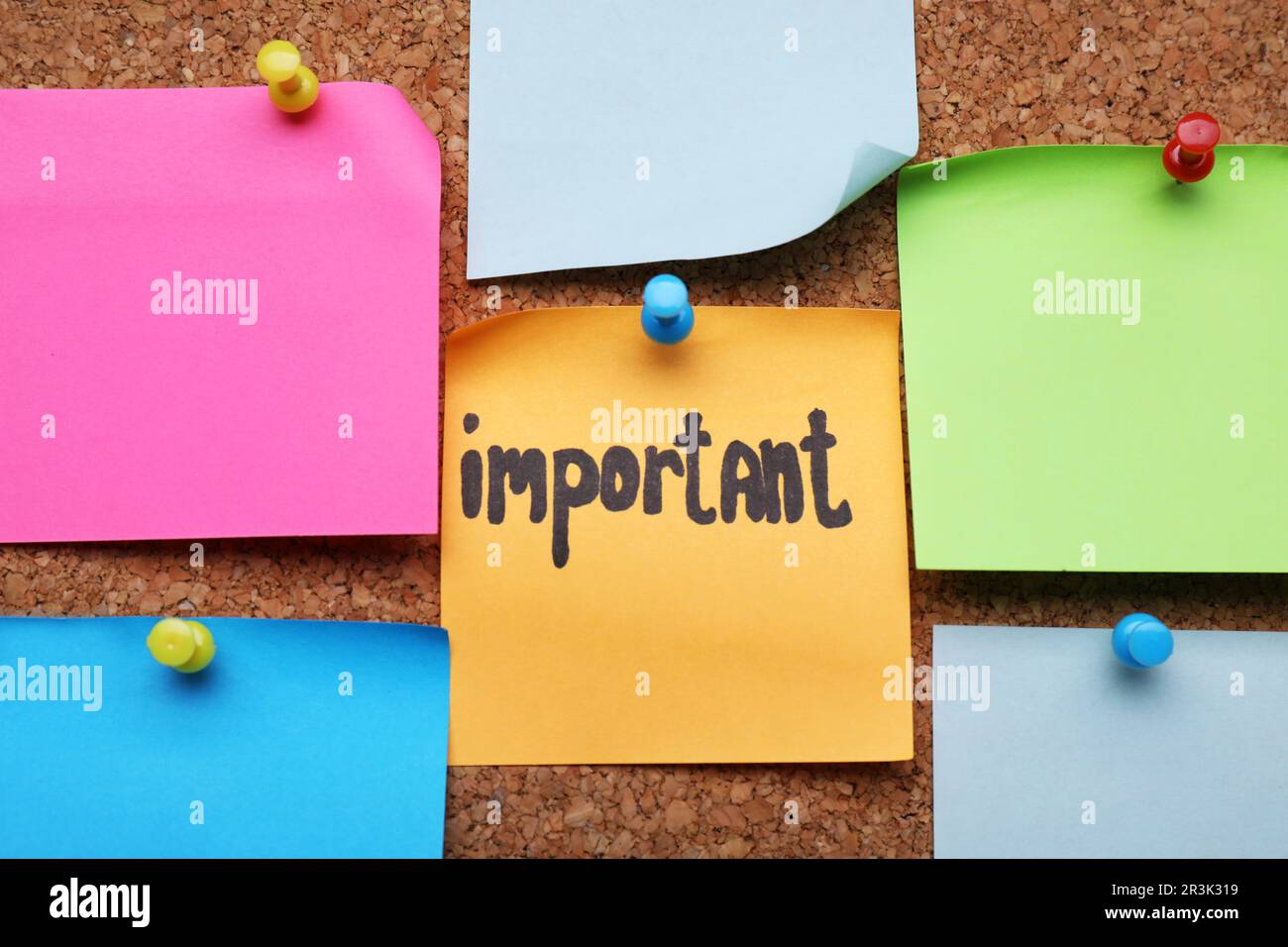 Different paper notes pinned to cork board, closeup Stock Photo