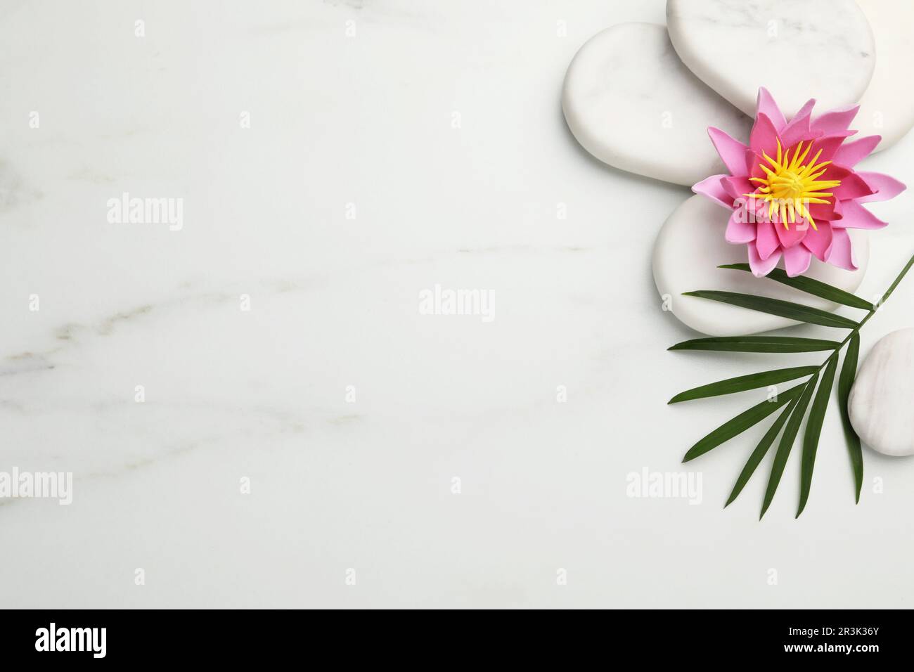 Flat lay composition with spa stones, lotus flower and leaf on white ...