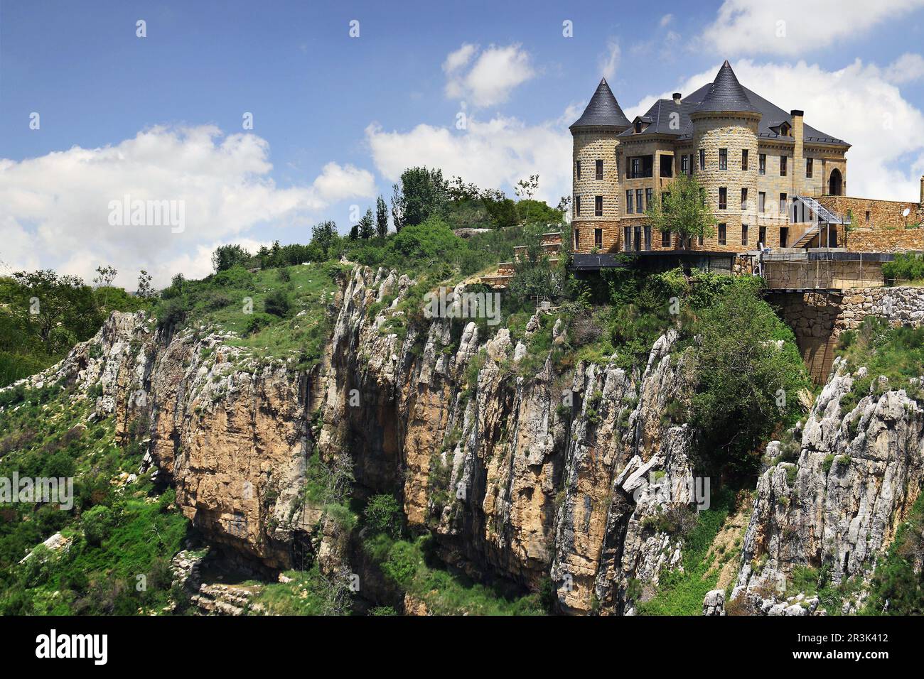 A castle with a black rooftop on a hilltop above fantastic rocks Stock ...