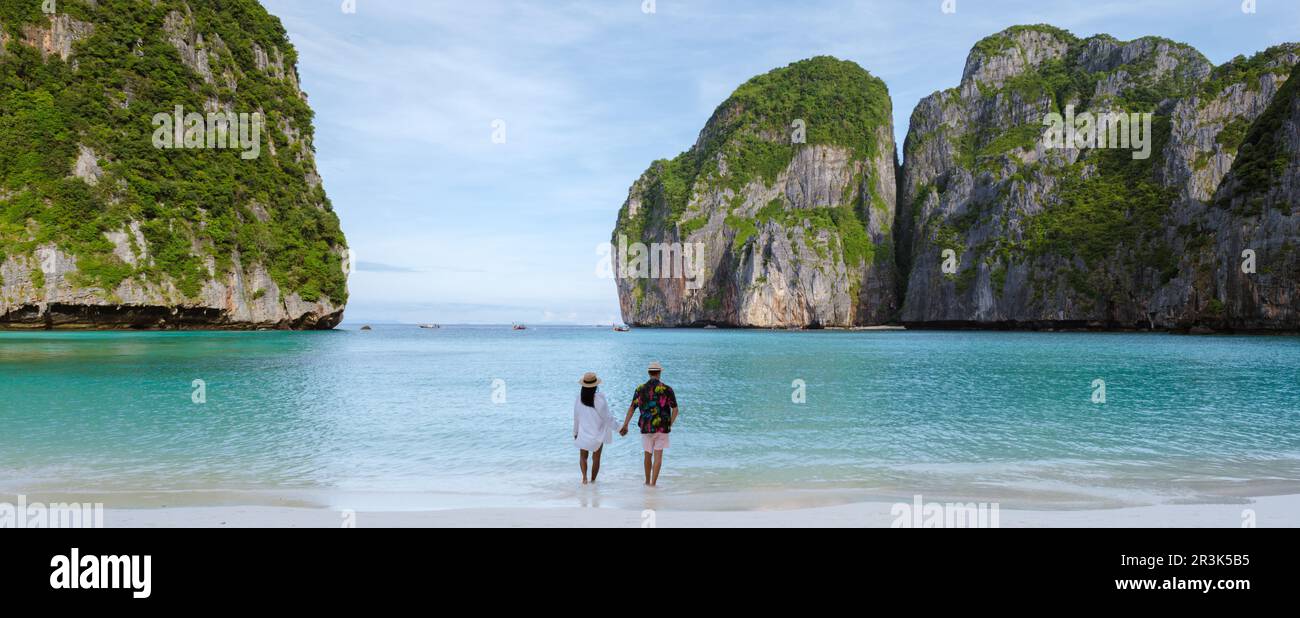 Couple men and women on honeymoon walking on a tropical beach Stock ...
