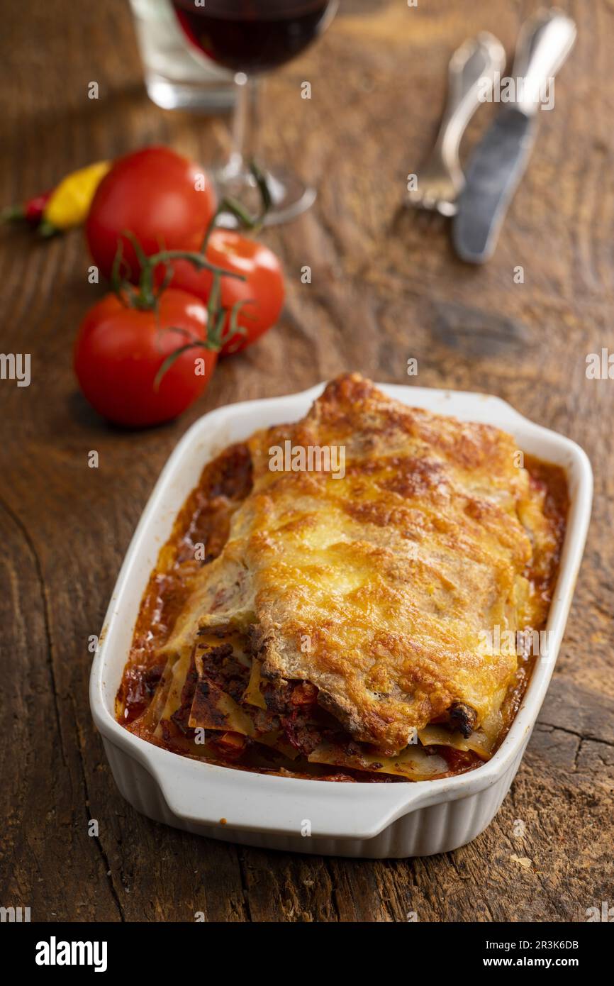 Lasagna in casserole on wood Stock Photo
