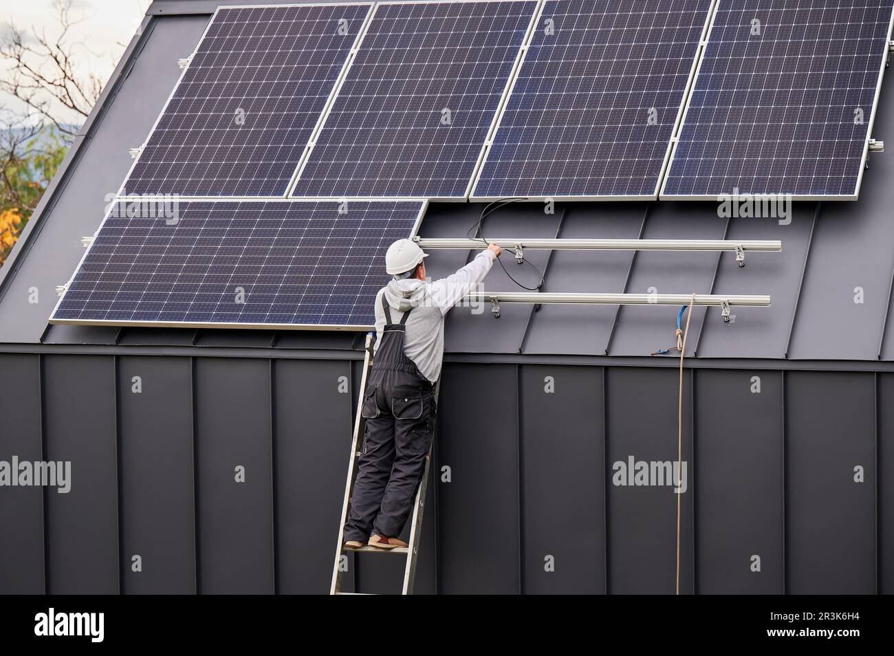 Electrician connecting cables while installing photovoltaic solar ...