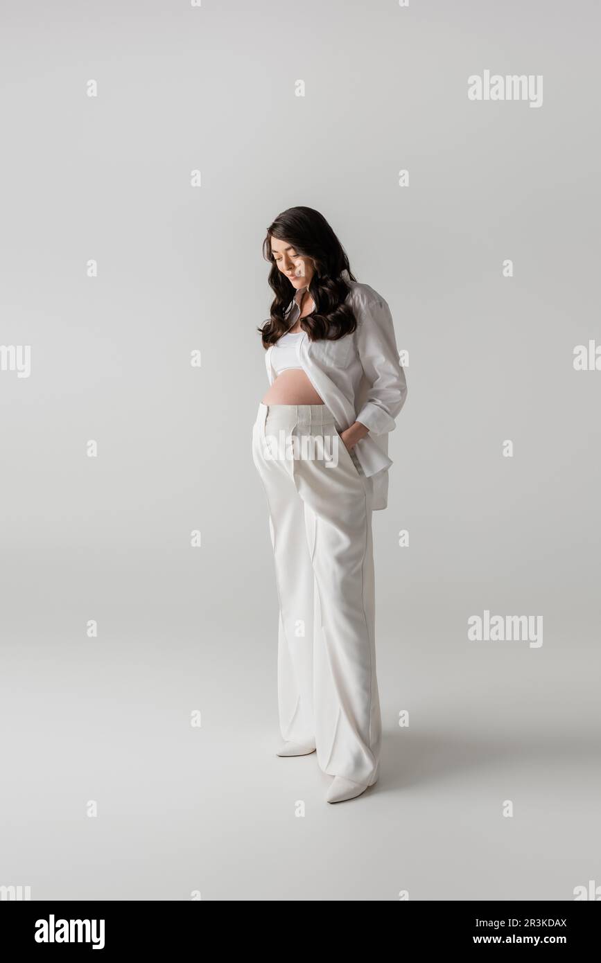Pregnant woman in white shirt hi-res stock photography and images - Alamy
