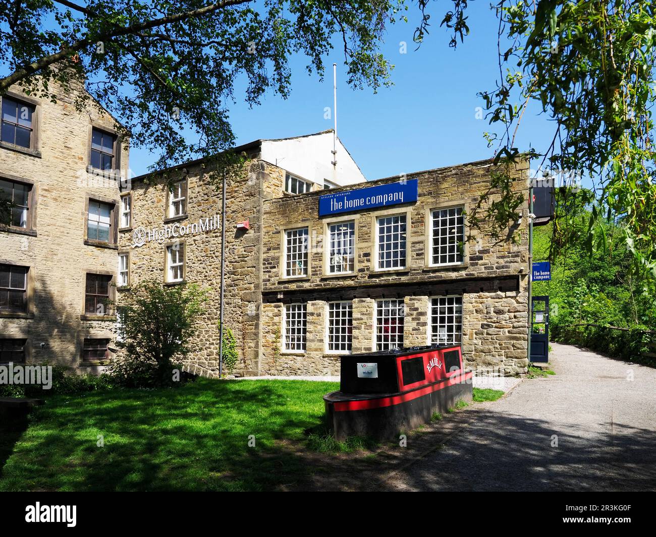 High Corn Mill housing businesses and a working water wheel at Skipton North Yorkshire England Stock Photo