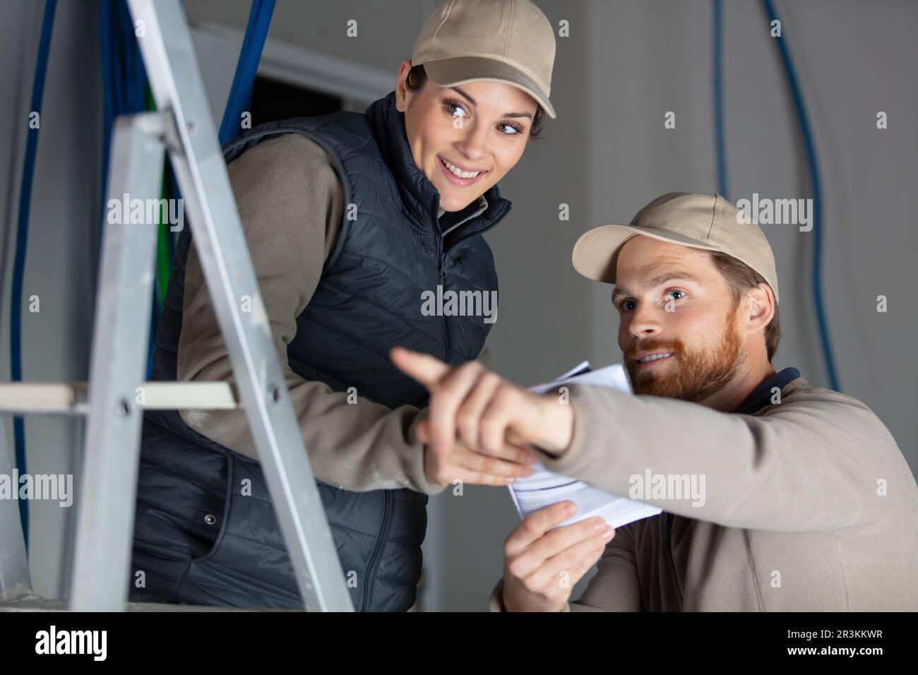 electricians taking measurements in construction site Stock Photo