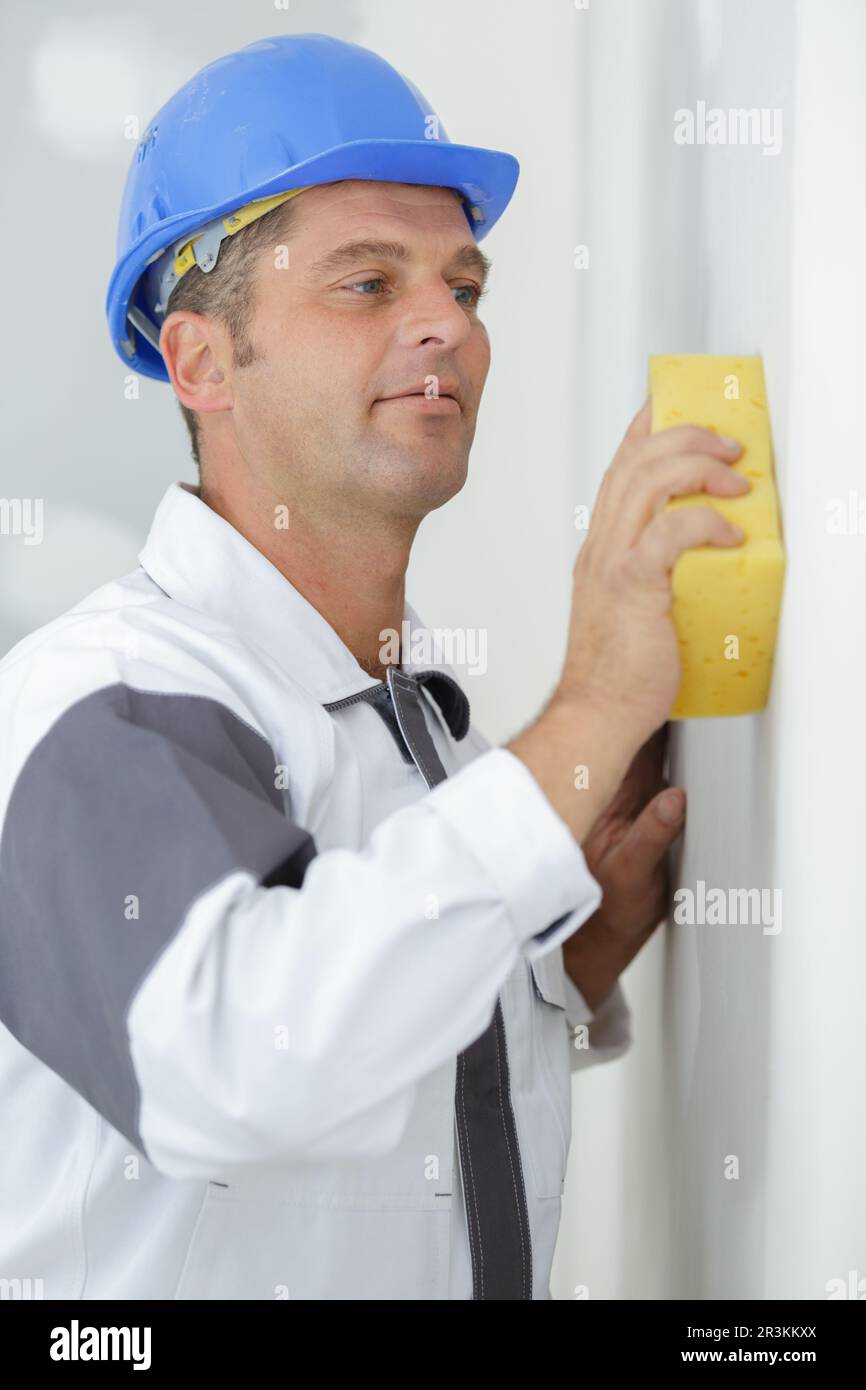 polishing plastered walls with sponge Stock Photo Alamy