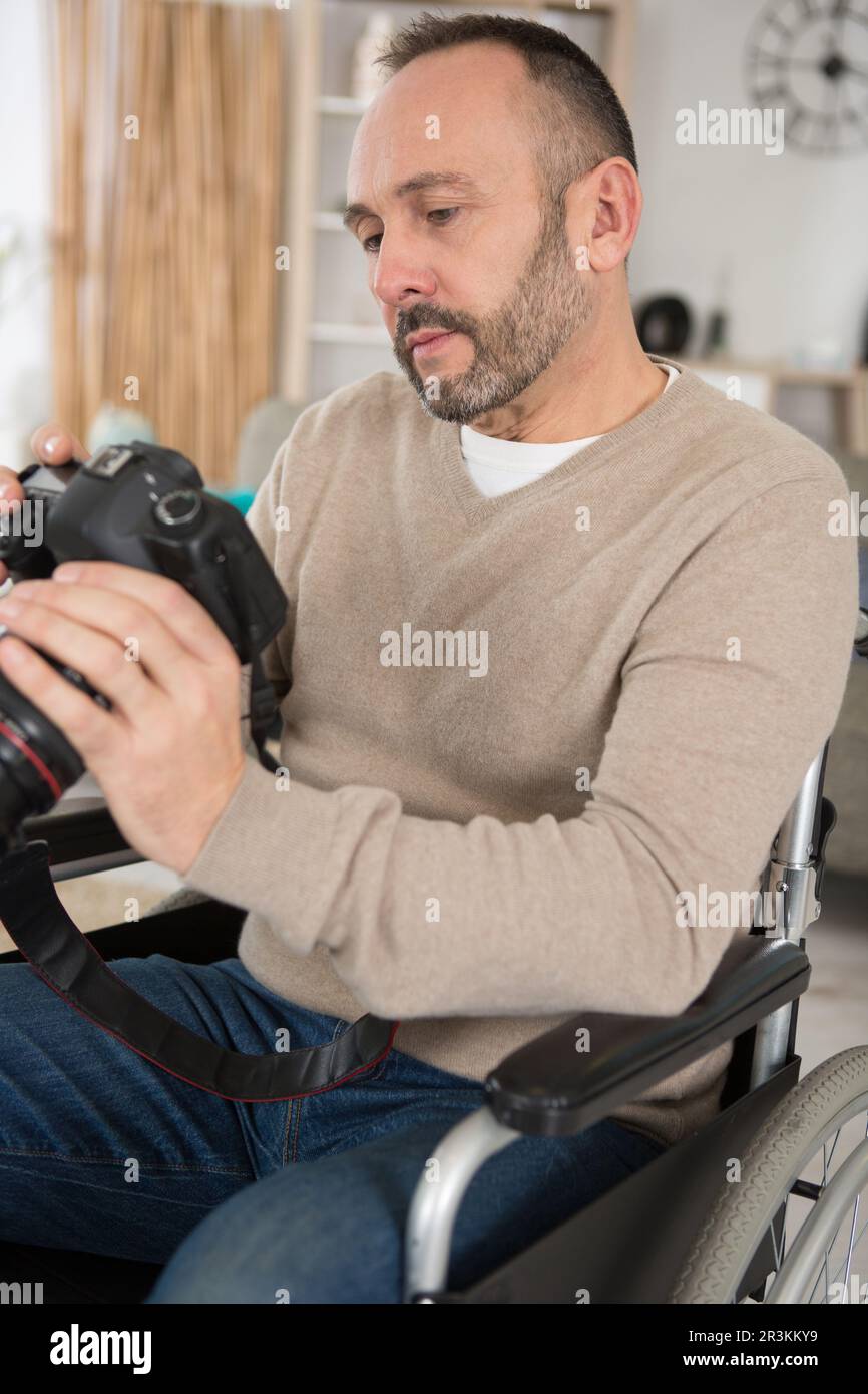 man in wheelchair training to become photographer Stock Photo