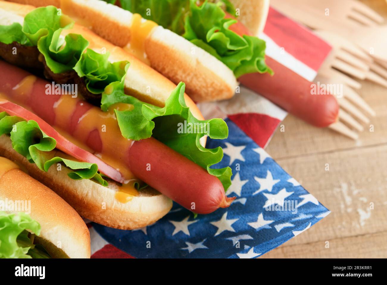 4th of July American Independence Day traditional picnic food. Hot dog with potato chips and cocktail, American flags and symbols of USA Patriotic pic Stock Photo