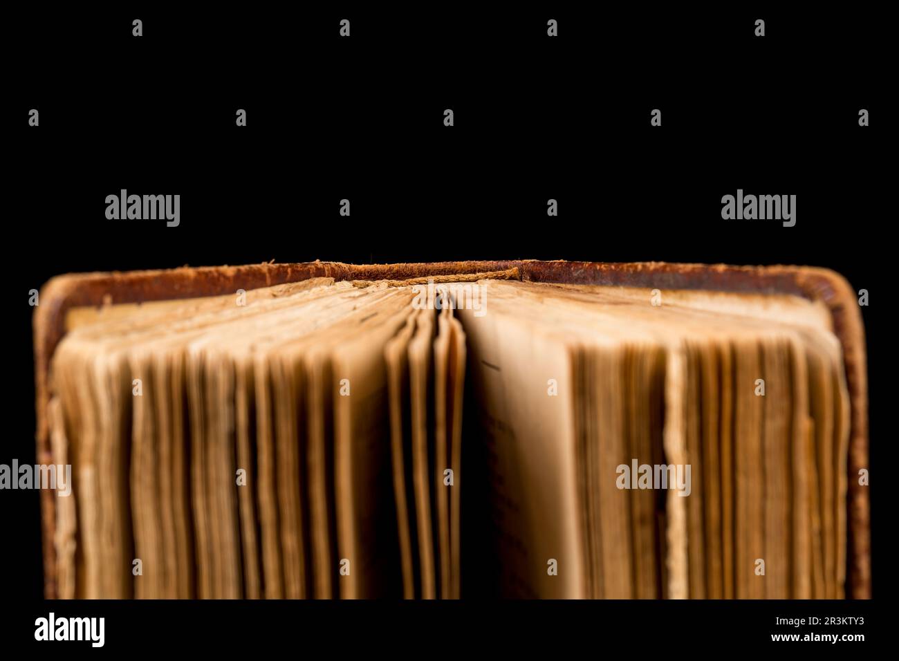 ancient book shot on black background. The book is in bad condition ...