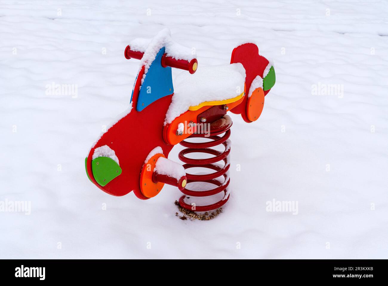 Swing car on a spring on the playground under the snow Stock Photo