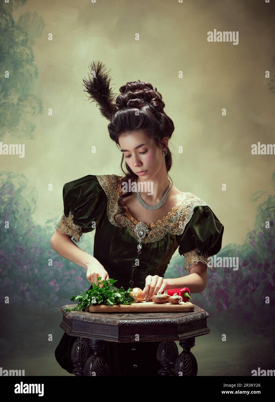 Portrait of tender young girl, elegant princess in stylish medieval dress cooking, cutting vegetables against dark vintage background Stock Photo - Alamy Portrait of tender young girl, elegant princess in stylish medieval dress cooking, cutting vegetables against dark vintage background Stock Photo - Alamy