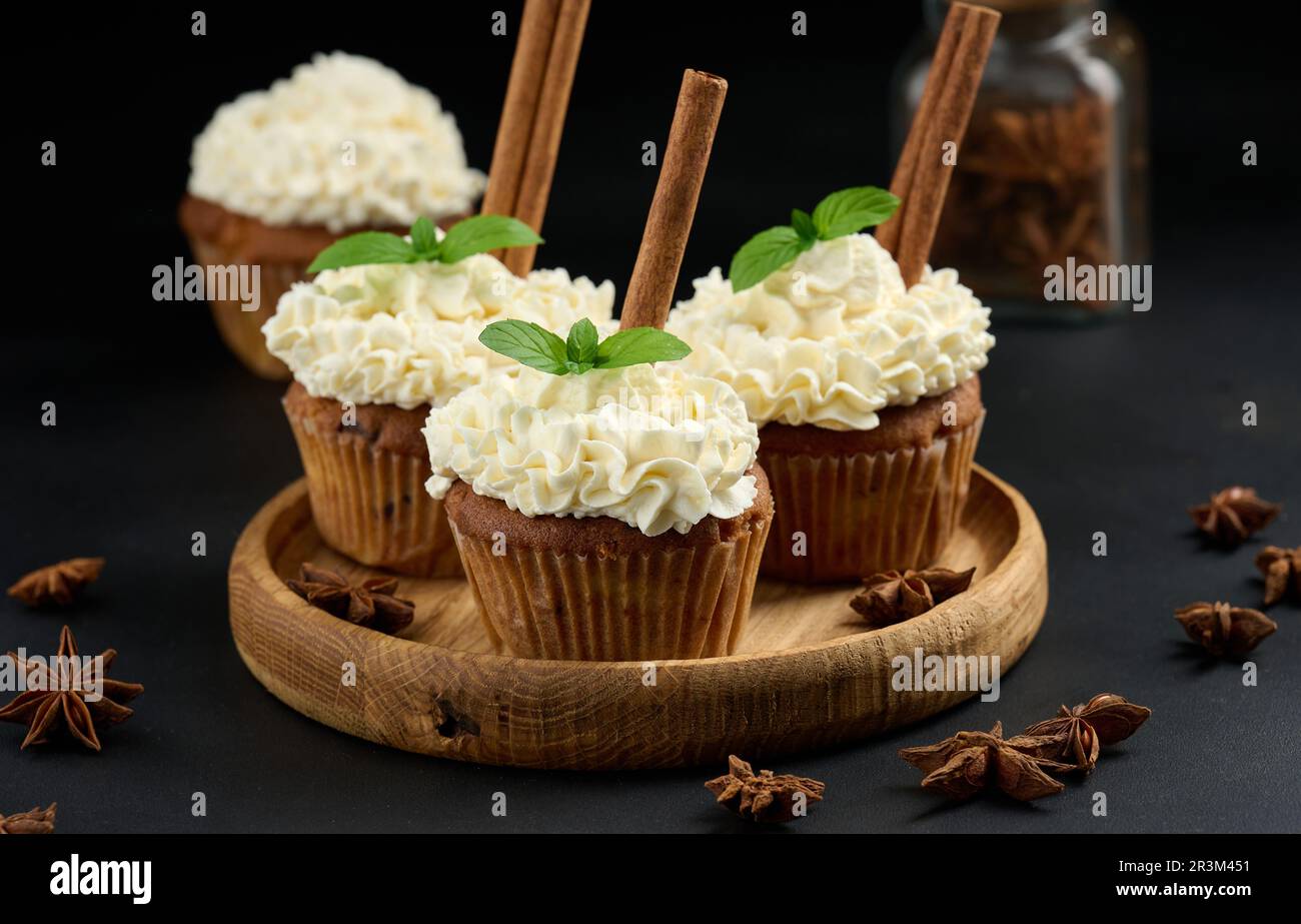 Baked cupcakes with white cream on the table, delicious dessert Stock Photo