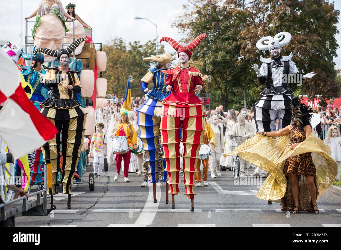 Stilt walkers in colorful costumes seen during the traditional Winobranie Wine Festival Parade. The local winemakers and artists, schools, as well as the residents of Zielona Gora take part in it, strolling down the main streets of the city in colourful disguises. Zielona Gora Wine Fest is a wine festival held in the Polish town of Zielona Gora. Winobranie is the biggest wine festival in Poland. The first festival took place in October 1852.During the Winobranie Wine Festival week, Bacchus, the god of wine and a symbol of Zielona Gora, gets the keys to the city and thus takes a power over it. Stock Photo