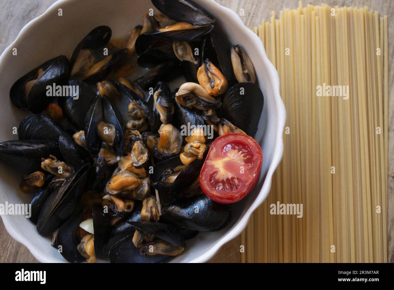fish first course typical of italian cuisine: pasta with mussels and freshn tomato Stock Photo