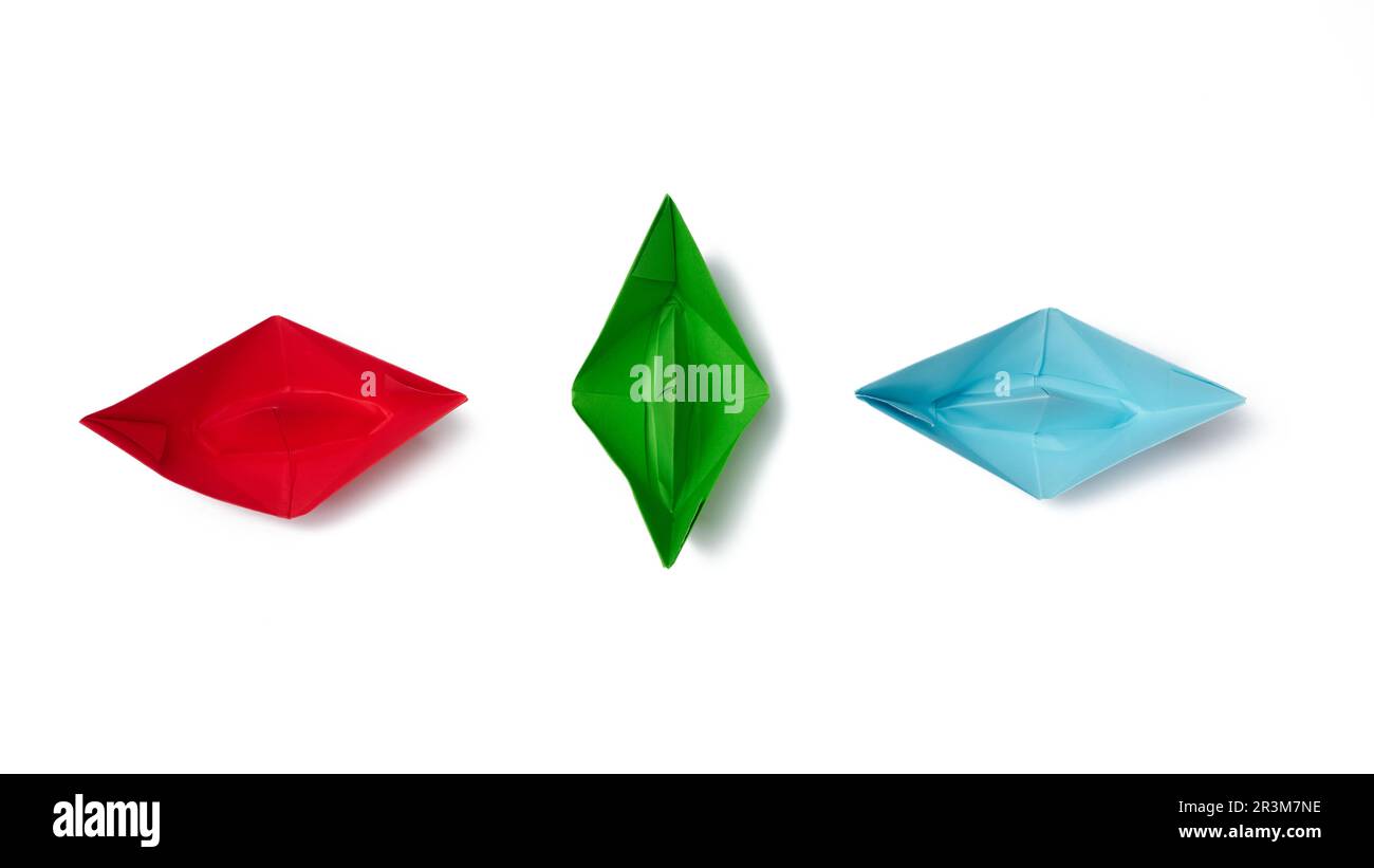 Three paper boats on a white background, top view Stock Photo